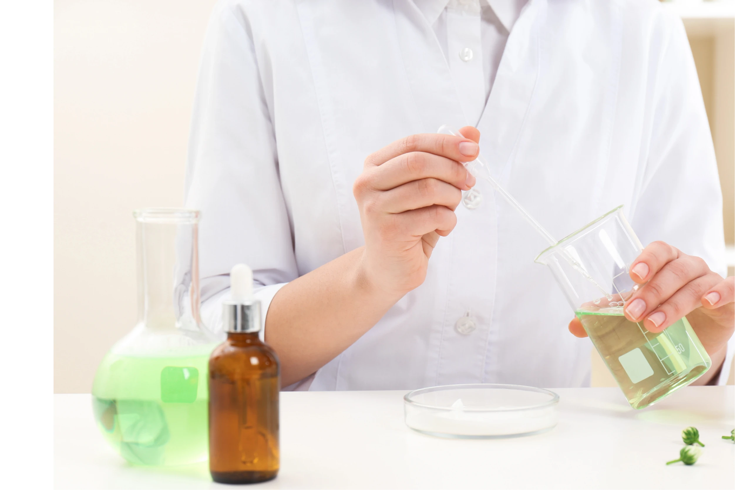Pharmacist preparing liquid medication in a compounding laboratory